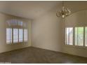 Spacious living room with shuttered windows and chandelier provides lots of natural light at 9142 E La Posada Ct, Scottsdale, AZ 85255