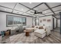 Cozy living room with a large sectional, gray trim, ceiling fan and checkerboard rug at 11530 E Vine Ave, Mesa, AZ 85208