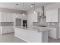 Modern kitchen featuring white cabinets, stainless steel appliances, and a large center island at 12022 W Marguerite Ave, Avondale, AZ 85323