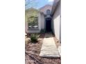 Inviting front entrance with desert landscaping and a walkway leading to the front door at 13001 W Aster Dr, El Mirage, AZ 85335