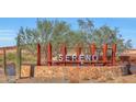 Sereno, A Mattamy Home Community, featuring a stone base and desert landscaping at 13448 W Auburn Dr, Peoria, AZ 85383
