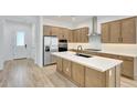 Spacious kitchen features stainless steel appliances, custom cabinets, large island and modern finishes at 13448 W Auburn Dr, Peoria, AZ 85383