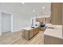 This kitchen showcases custom cabinets, an island, tile backsplash, stainless appliances and room to entertain at 13448 W Auburn Dr, Peoria, AZ 85383