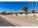 Single-story home with a charming desert landscape and well-maintained front yard at 1434 W Meseto Ave, Mesa, AZ 85202