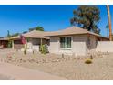 A well maintained single-story home featuring desert landscaping and a warm, inviting exterior at 1434 W Meseto Ave, Mesa, AZ 85202