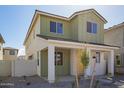 Stylish two-story home with neutral colors, a front porch, and simple desert landscaping at 15584 S 180Th Ln, Goodyear, AZ 85338