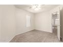 Cozy bedroom with neutral paint, tile flooring, and a ceiling fan at 16802 N 20Th St, Phoenix, AZ 85022