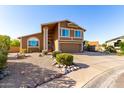 Two-story home boasts a desert landscape, spacious driveway, and inviting curb appeal at 17466 N 64Th Ave, Glendale, AZ 85308