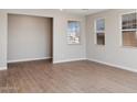 Neutral-toned living area featuring wood-look tile floors and bright windows at 21248 N 58Th St, Phoenix, AZ 85054