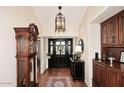 Elegant foyer with hardwood floors, a striking black door, and classic furnishings, creating a warm welcome at 25 E San Miguel E Ave, Phoenix, AZ 85012