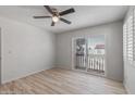 Bright bedroom with wood-look floors, ceiling fan, and sliding glass door to balcony at 2828 E Waltann Ln # 1, Phoenix, AZ 85032