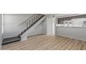 Spacious living room featuring wood-look flooring and a staircase leading to upper level at 2828 E Waltann Ln # 1, Phoenix, AZ 85032