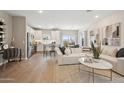Sun-lit open floor plan featuring modern decor, white sofa, and stainless steel appliances at 2843 W Eagle Talon Rd, Phoenix, AZ 85085