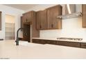 Close-up of the kitchen island featuring white counters, stylish faucet, and stainless steel appliances at 40165 N Alameda Dr, San Tan Valley, AZ 85140