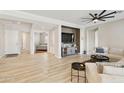 Spacious living room featuring wood floors, neutral colors, ceiling fan and open floor plan at 4214 E Donato Dr, Gilbert, AZ 85298