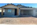 New home construction showing the unfinished exterior facade, garage and front porch with natural wood pillars at 5629 W Mcneil St, Laveen, AZ 85339