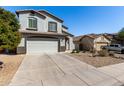 Two-story home boasts a neutral stucco exterior, two-car garage, and low maintenance landscaping at 706 W Green Tree Dr, San Tan Valley, AZ 85143
