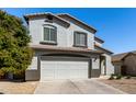Two-story home boasts a neutral stucco exterior, two-car garage, and easy-care landscaping at 706 W Green Tree Dr, San Tan Valley, AZ 85143