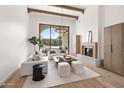 Open living space with a fireplace, modern furnishings, and sliding glass doors to the backyard at 7157 E Bronco Dr, Paradise Valley, AZ 85253