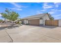 Street view of home with spacious driveway and well-maintained landscaping at 8049 E Des Moines St, Mesa, AZ 85207