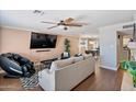 Cozy living room featuring modern decor, hardwood floors, a comfortable couch, and an entertainment center at 8213 E Whitton Ave, Scottsdale, AZ 85251