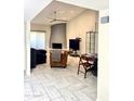 Spacious living area with fireplace, TV, seating, and plenty of natural light at 8302 N 21St Dr # L204, Phoenix, AZ 85021