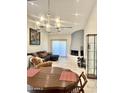 Open floor plan with tile floors, a modern fireplace, and stylish lighting fixtures at 8302 N 21St Dr # L204, Phoenix, AZ 85021