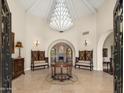 Grand foyer showcasing soaring ceilings, travertine floors, custom woodwork and designer lighting at 8712 N 64Th Pl, Paradise Valley, AZ 85253