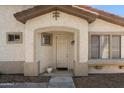 Charming front entryway with a beige door, desert landscaping, and stucco walls at 1024 E Frye Rd # 1063, Phoenix, AZ 85048