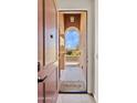 Inviting entryway with a 'Welcome' doormat, arched doorframe and view of front yard at 1051 W Inca St, Mesa, AZ 85201