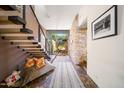 Elegant entryway showcases modern stairs, stone wall, and large windows, creating a grand entrance at 10801 E Happy Valley Rd # 4, Scottsdale, AZ 85255