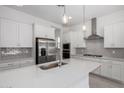 Bright, modern kitchen with stainless steel appliances, quartz countertops, and stylish pendant lighting at 12029 W Marguerite Ave, Avondale, AZ 85323