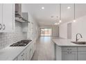 Open concept kitchen with quartz countertops, subway tile backsplash and stainless steel appliances at 12029 W Marguerite Ave, Avondale, AZ 85323