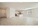 Open concept living area featuring tile floors, ample light, and a view of the kitchen at 15065 W Hackamore Dr, Surprise, AZ 85387