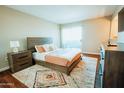 Cozy bedroom with a sliding glass door, soft rug, and neutral decor at 1645 W Baseline Rd # 2026, Mesa, AZ 85202