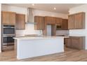 Well-equipped kitchen with modern cabinetry, stainless steel appliances, and a spacious center island at 1892 E Empeltre Rd, San Tan Valley, AZ 85140