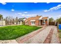Quaint home with brick-lined driveway and lush lawn, a lovely curb appeal at 1910 W Holly St, Phoenix, AZ 85009