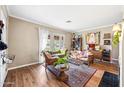 Bright living room featuring wood floors, a fireplace, and french doors leading to the outside at 1910 W Holly St, Phoenix, AZ 85009