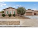 Charming single-story home featuring desert landscaping, a well-manicured lawn, and an attached two car garage at 23800 N 169Th Ave, Surprise, AZ 85387