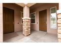 Inviting front porch with stone column detail and two front doors, offering privacy and curb appeal at 23800 N 169Th Ave, Surprise, AZ 85387