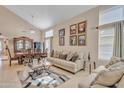 Comfortable living room showcasing stylish furniture, neutral tones, and ample natural light from large windows at 25038 W Rancho Vista Dr, Buckeye, AZ 85326