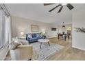 Stylish living room open to dining area, featuring modern furnishings and wood floors at 2604 W Wolf St, Phoenix, AZ 85017
