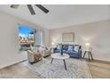 Cozy living room with a large window, modern furniture, and an area rug at 2604 W Wolf St, Phoenix, AZ 85017