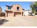 Charming two-story home with attached garage, well-kept landscaping, and expansive driveway at 28050 N Limestone Ln, San Tan Valley, AZ 85143
