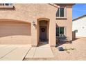 Cozy front entrance with festive wreath, covered porch, and desert-style front yard at 28050 N Limestone Ln, San Tan Valley, AZ 85143