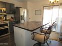 Kitchen with stainless appliances and a counter bar with two chairs and pendant lighting at 3004 W Running Deer Trl, Phoenix, AZ 85083