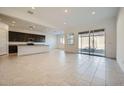 Spacious living room and kitchen featuring an open floor plan and sliding glass doors at 3252 W Peak View Rd, Phoenix, AZ 85083