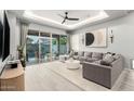 Bright living room with sliding glass doors to the pool area and modern gray furnishings at 3527 E Arabian Dr, Gilbert, AZ 85296