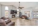 Inviting living room with a fireplace, high ceilings, and views of the pool at 3620 N Aspen Dr, Avondale, AZ 85392