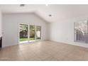 Bright, open living room with tile flooring, a sliding glass door, and lots of natural light at 405 E Wescott Dr, Phoenix, AZ 85024